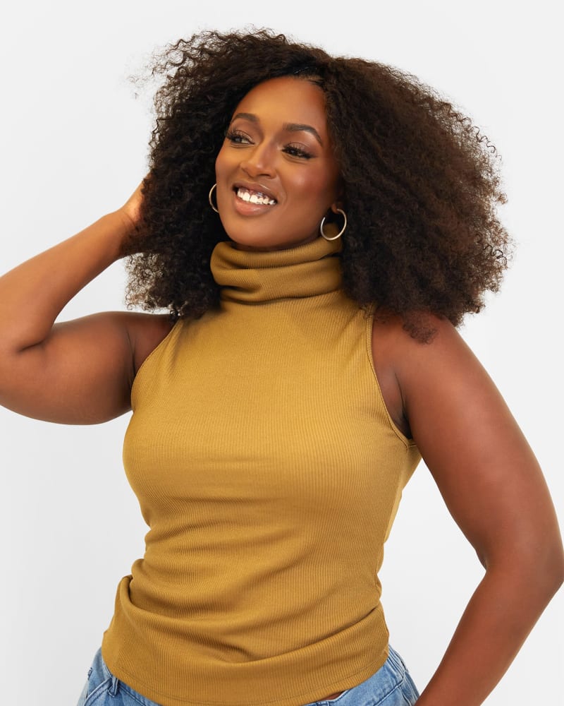 Side of a model wearing a size 1X Connie Ribbed High Neck Full Length Top - Khaki in Brown by Rebdolls. | dia_product_style_image_id:321290